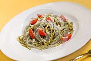Spaghetti with basil pesto and tomatoes