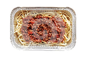 Spaghetti bolognese in aluminium foil box isolated on white background. Selective focus. Concept for take away and delivery food.