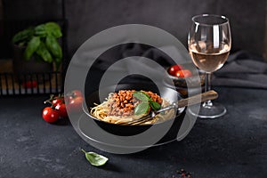Spaghetti bolognese in a black bowl