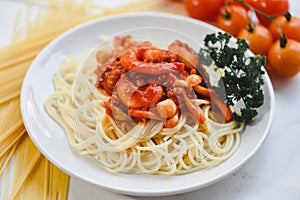 Spaghetti bolognese italian pasta with shrimp prawn served on white plate with tomato parsley in the restaurant italian food and