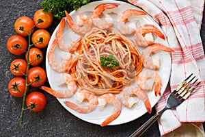 Spaghetti bolognese italian pasta with shrimp prawn served on white plate with tomato parsley in the restaurant italian food and