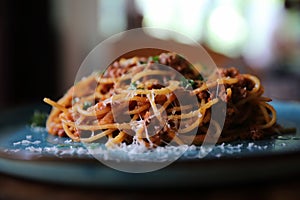 Spaghetti Bolognese with minced beef and tomato sauce garnished with parmesan cheese and basil , Italian food