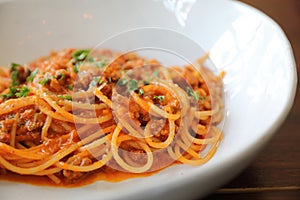 Spaghetti Bolognese with minced beef and tomato sauce garnished with parmesan cheese and basil , Italian food