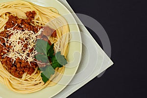 Spaghetti bolognese on a plate with kitchen napkin