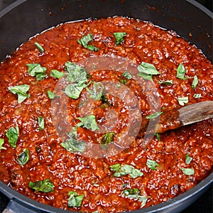 Spaghetti bolognese sauce with fresh basil