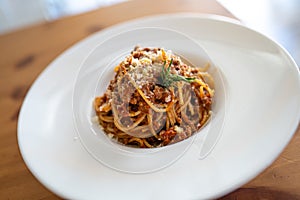 Spaghetti bolognese served on a white plate