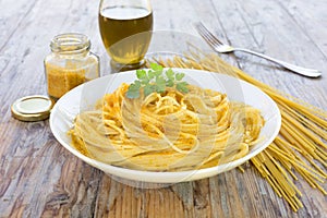 Spaghetti with bottarga on wooden table