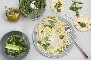 Spaghetti with broccoli paste and fork on ceramic plate