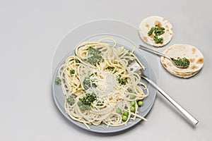 Spaghetti with broccoli paste and fork on ceramic plate