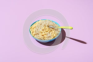 Spaghetti cacio e pepe bowl, isolated on a purple background
