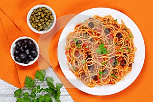 Spaghetti with capers. olives, anchovies, tomato sauce
