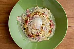 The spaghetti carbonara with egg boiled.