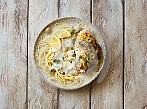 Spaghetti with creamy lemon sauce and fried chicken breast