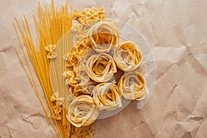 Spaghetti, farfalle and tagliatelle isolated on a white background.