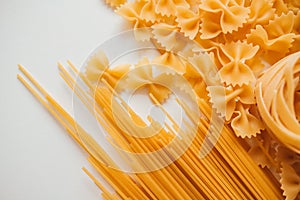 Spaghetti, farfalle and tagliatelle isolated on a white background.