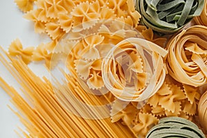 Spaghetti, farfalle and tagliatelle isolated on a white background.