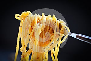Spaghetti fork on dark black background - Traditional delicious food tasty appetizing classic italian spaghetti pasta