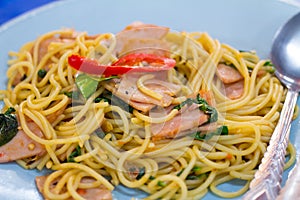 Spaghetti with fried crispy bacon ,sausage and basil leave, hot and spicy food, international cuisine
