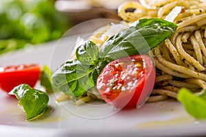 Spaghetti. Italian pasta spaghetti with basil pesto cherry tomatoes and olive oil