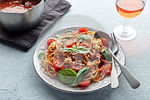 Spaghetti marinara, pasta with tomato sauce and basil, with wine