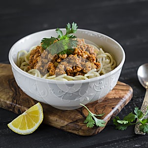 Spaghetti with meat Bolognese sauce in a white bowl