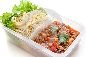 Spaghetti meat sauce ready to eat in lunch box, on white background isolated