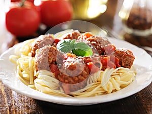 Spaghetti and meatballs with basil garnish