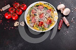 Spaghetti with mushrooms, cheese, spinach, rukkola and cherry tomatoes