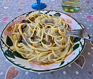 Spaghetti with mussels on a hearts tablecloth photo