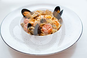 Spaghetti with mussels seafood. Soba noodles with shrimps and vegetables. Asian food. Pasta with seafood in tomato sauce.