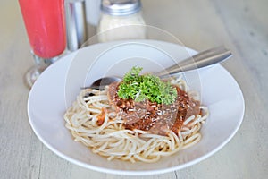 Spaghetti Napoli on table in restaurant.