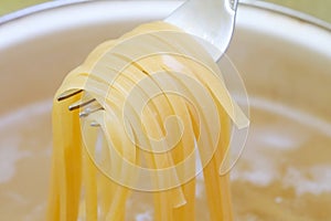 Spaghetti in pan cooking in boiling water, cooking pasta