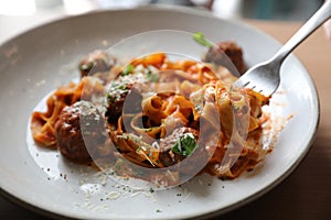 Spaghetti pasta with beef meatballs and tomato sauce on a dish , italian food