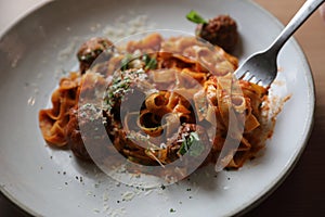 Spaghetti pasta with beef meatballs and tomato sauce on a dish , italian food