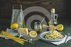 Spaghetti pasta bucatini with pesto sauce and parmesan. Italian traditional perciatelli pasta by genovese pesto sauce in gray dish