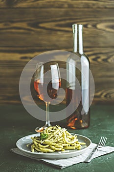 Spaghetti pasta bucatini with pesto sauce and parmesan. Italian traditional perciatelli pasta by genovese pesto sauce in gray dish