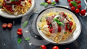 Spaghetti pasta meatballs with tomato sauce, basil, herbs parmesan cheese on dark background