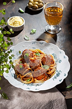 Spaghetti pasta with meatballs, tomato sauce and fresh basil