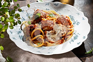 Spaghetti pasta with meatballs, tomato sauce and fresh basil