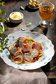 Spaghetti pasta with meatballs, tomato sauce and fresh basil