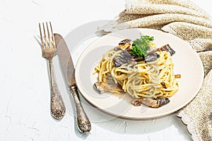 Spaghetti pasta with oyster mushrooms, creamy sauce and parsley. Healthy vegan food ready to eat