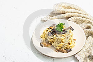 Spaghetti pasta with oyster mushrooms, creamy sauce and parsley. Healthy vegan food ready to eat