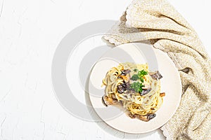 Spaghetti pasta with oyster mushrooms, creamy sauce and parsley. Healthy vegan food ready to eat