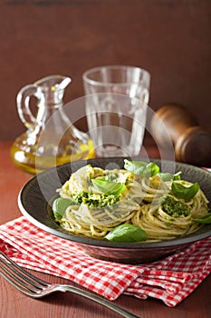 Spaghetti pasta with pesto sauce over rustic table