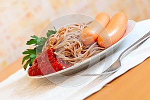 Spaghetti pasta with sausages and tomato catchup