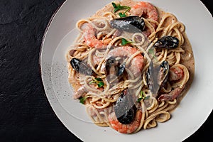 Spaghetti, pasta, with seafood, shrimp with mussels, in creamy garlic sauce, homemade, no people,