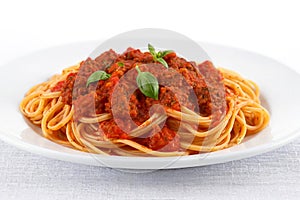 Spaghetti pasta with tomato beef sauce in plate, cut out on white background