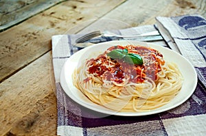 Spaghetti Pasta with Tomato Sauce, Cheese and Basil on Wooden Table. Traditional Italian Food