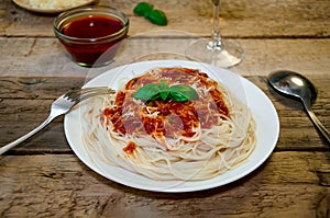 Spaghetti Pasta with Tomato Sauce, Cheese and Basil on Wooden Table. Traditional Italian Food