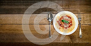 Spaghetti Pasta with Tomato Sauce, Cheese and Basil on Wooden Table. Traditional Italian Food.